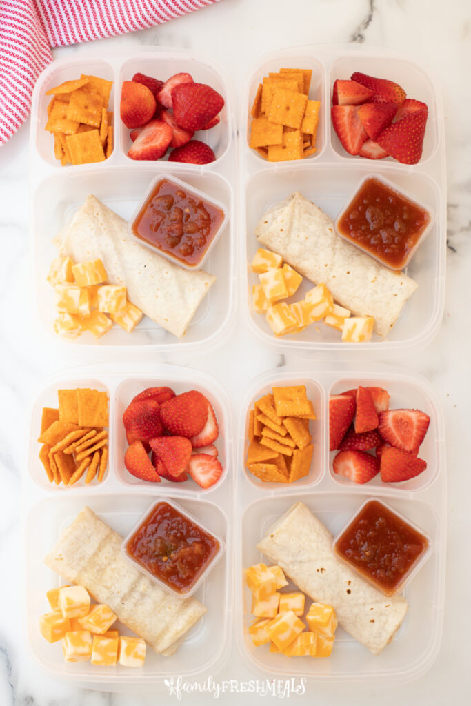 4 lunch boxes filled with burritos, strawberries, crackers, cheese and salsa-5