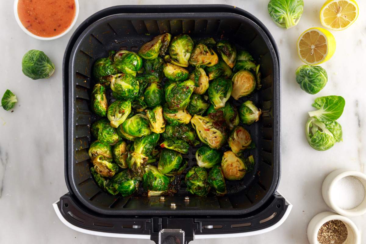 Air Fryer Cooked Bang Bang Brussels Sprouts in Fryer Basket