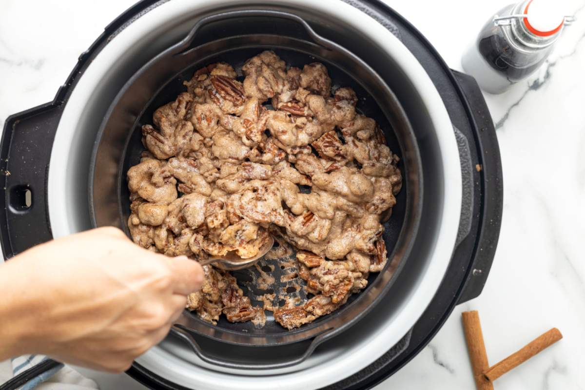 stirring the nuts in the deep fryer