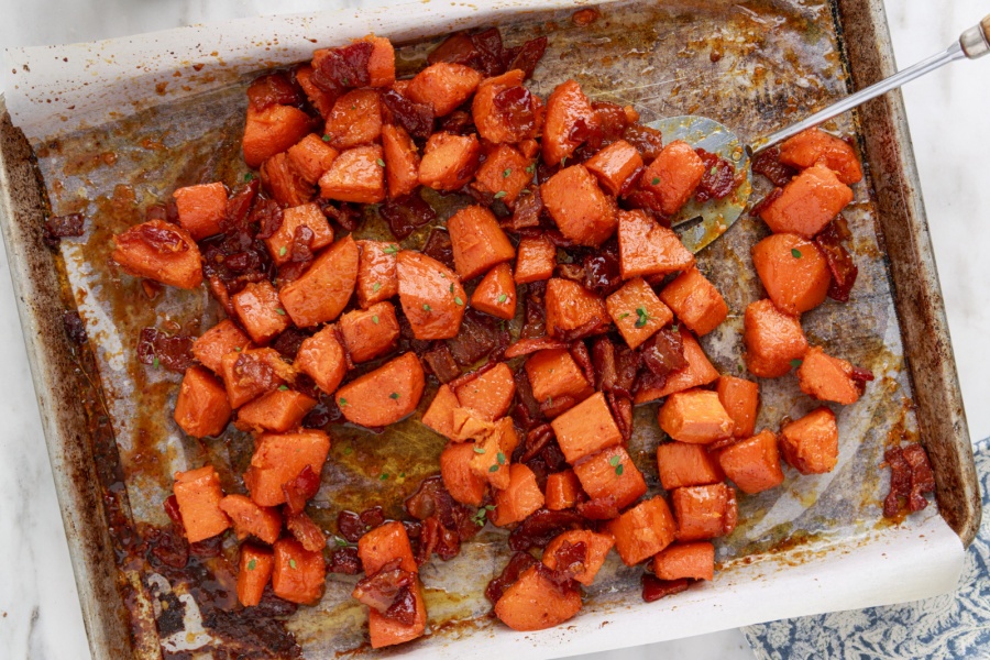 Candied yams with bacon on a baking sheet