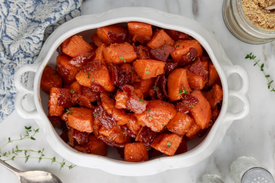 Candied yams with bacon on a serving plate