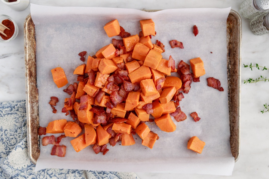 yams and bacon on a baking sheet