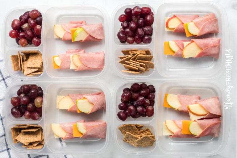 4 lunch boxes with ham, apple and cheese wraps