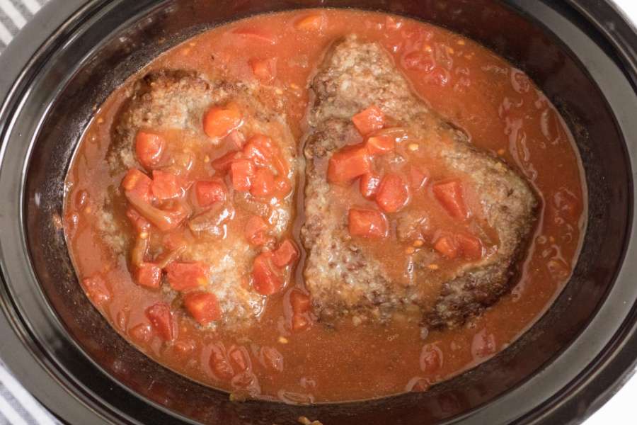 cune steaks added to sauce in a slow cooker