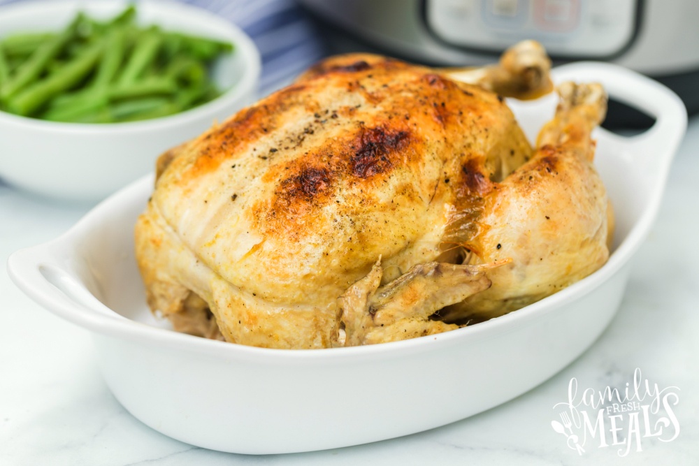 Instant Pot Dill Pickle Chicken Recipe - whole chicken cooked in a white baking dish