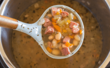This Instant Pot Ham and Bean Soup can also be made in your slow cooker.  It's packed with fresh vegetables, beans, and is the perfect recipe for leftover ham.  #instantpot #ham #bean #soup via @familyfresh