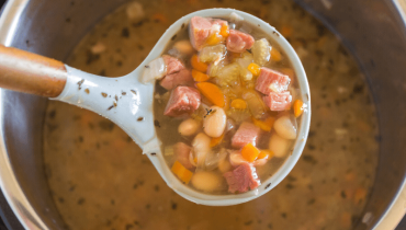 This Instant Pot Ham and Bean Soup can also be made in your slow cooker.  It's packed with fresh vegetables, beans, and is the perfect recipe for leftover ham.  #instantpot #ham #bean #soup via @familyfresh