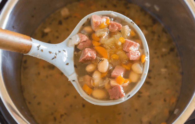 This Instant Pot Ham and Bean Soup can also be made in your slow cooker.  It's packed with fresh vegetables, beans, and is the perfect recipe for leftover ham.  #instantpot #ham #bean #soup via @familyfresh