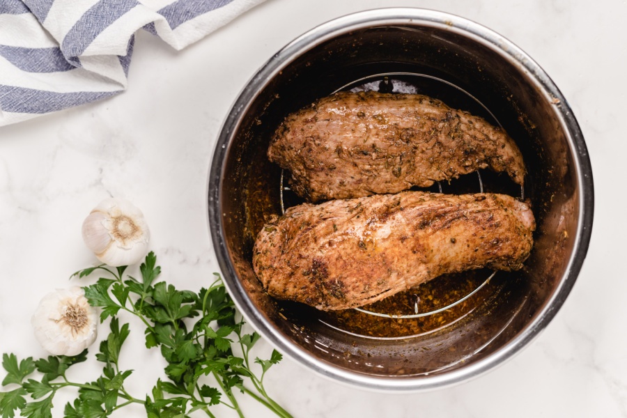 trivet placed on Instant Pot and pork placed on top