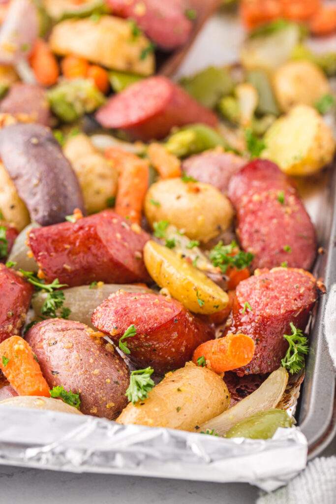 Sausages and potatoes on a baking sheet