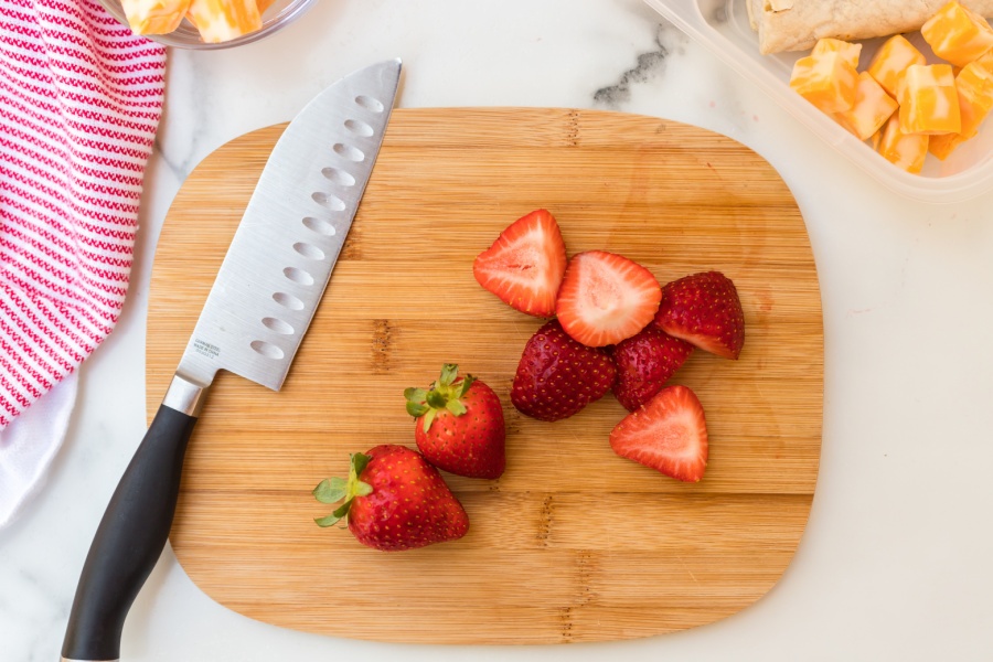 Strawberries cut on a cutting board