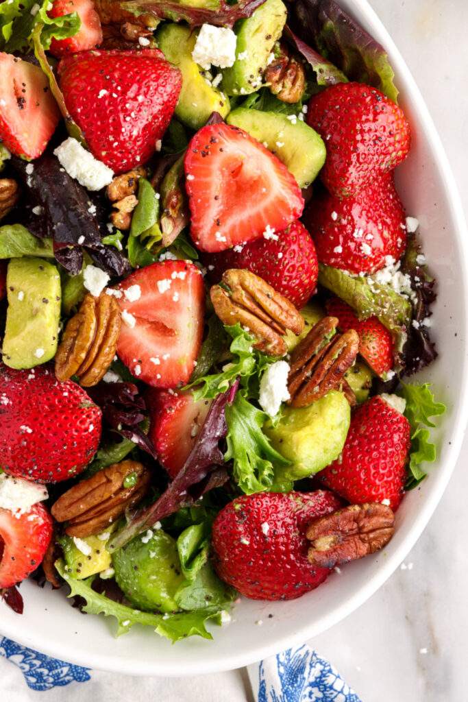 Avocado and strawberry salad in white bowl