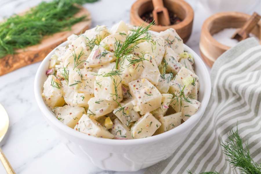 potato salad with dill in a bowl