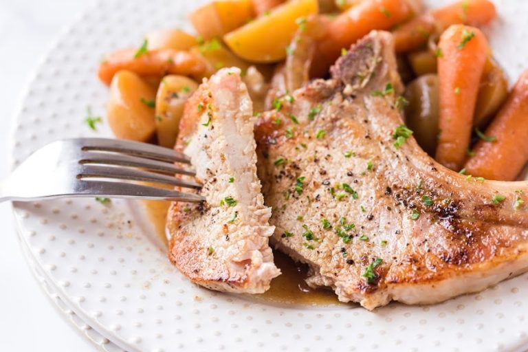 pork-chop-on-a-white-plate-with-carrots-and-potatoes