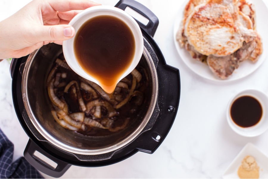 pour broth into instant pot with onions