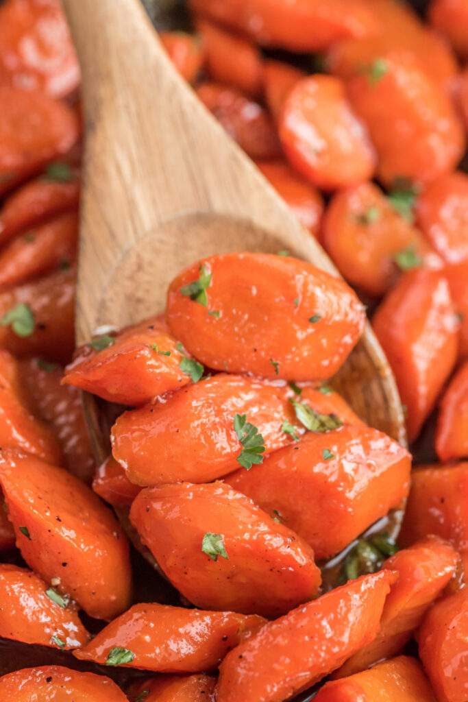 Spoon to scoop up some honey and brown sugar glazed carrots