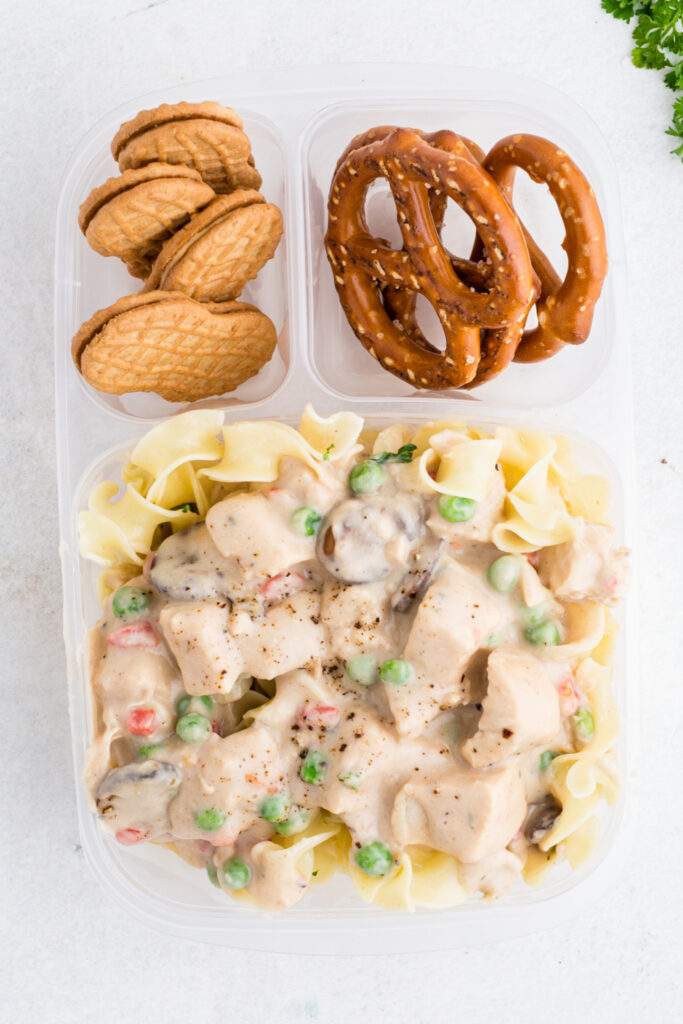 Chicken A La King packed in a lunch box with pretzels and crackers