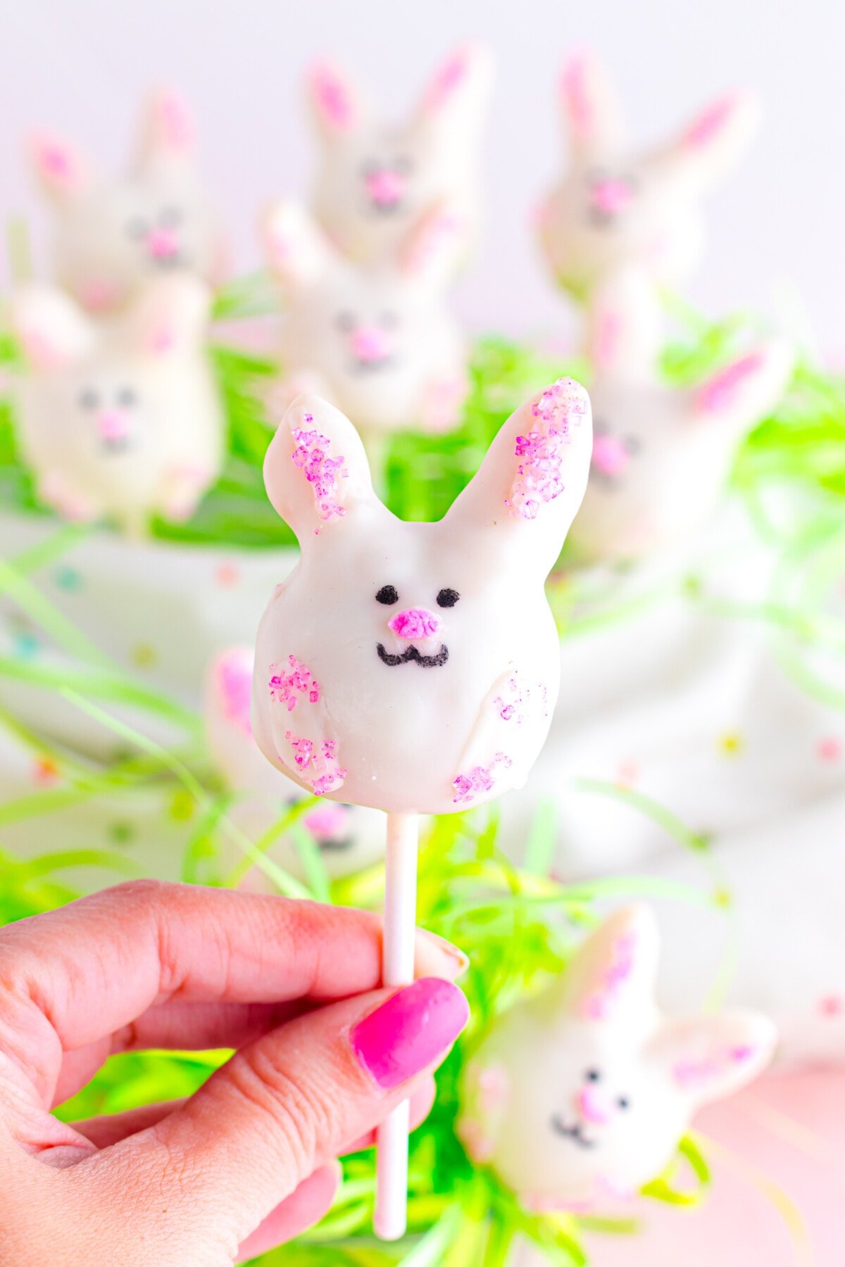 A hand holding one of the Easter Cake Pops.