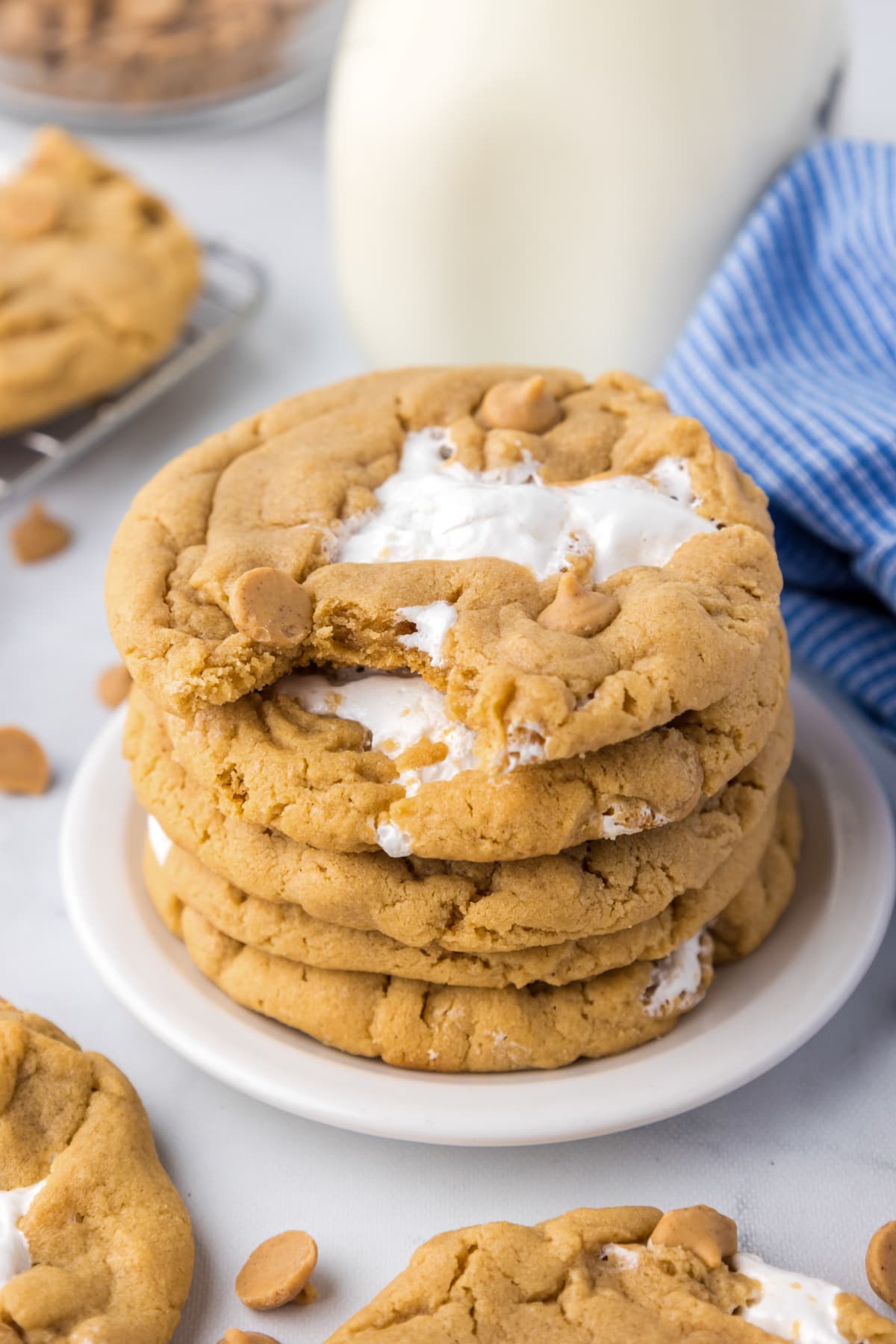 fluffernutter biscuits with bite stacked on a white plate with milk