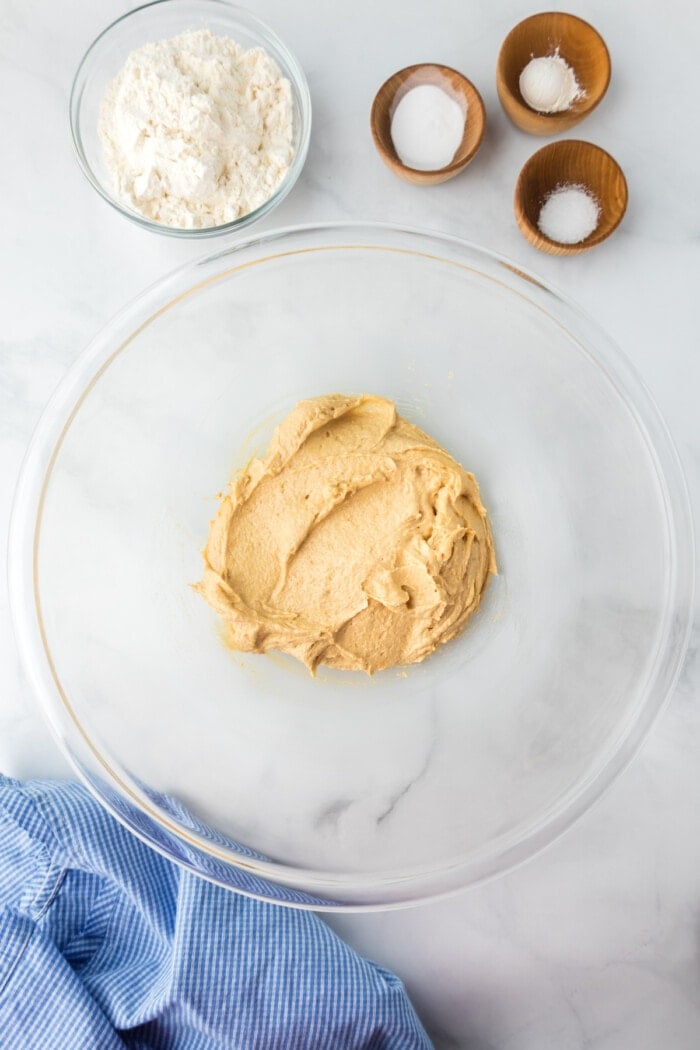 peanut butter and butter mixed in a clear glass bowl