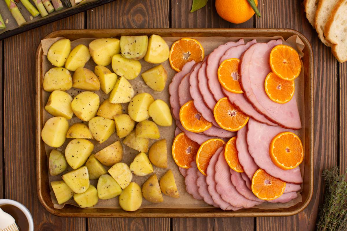 orange slices placed between the slices of ham