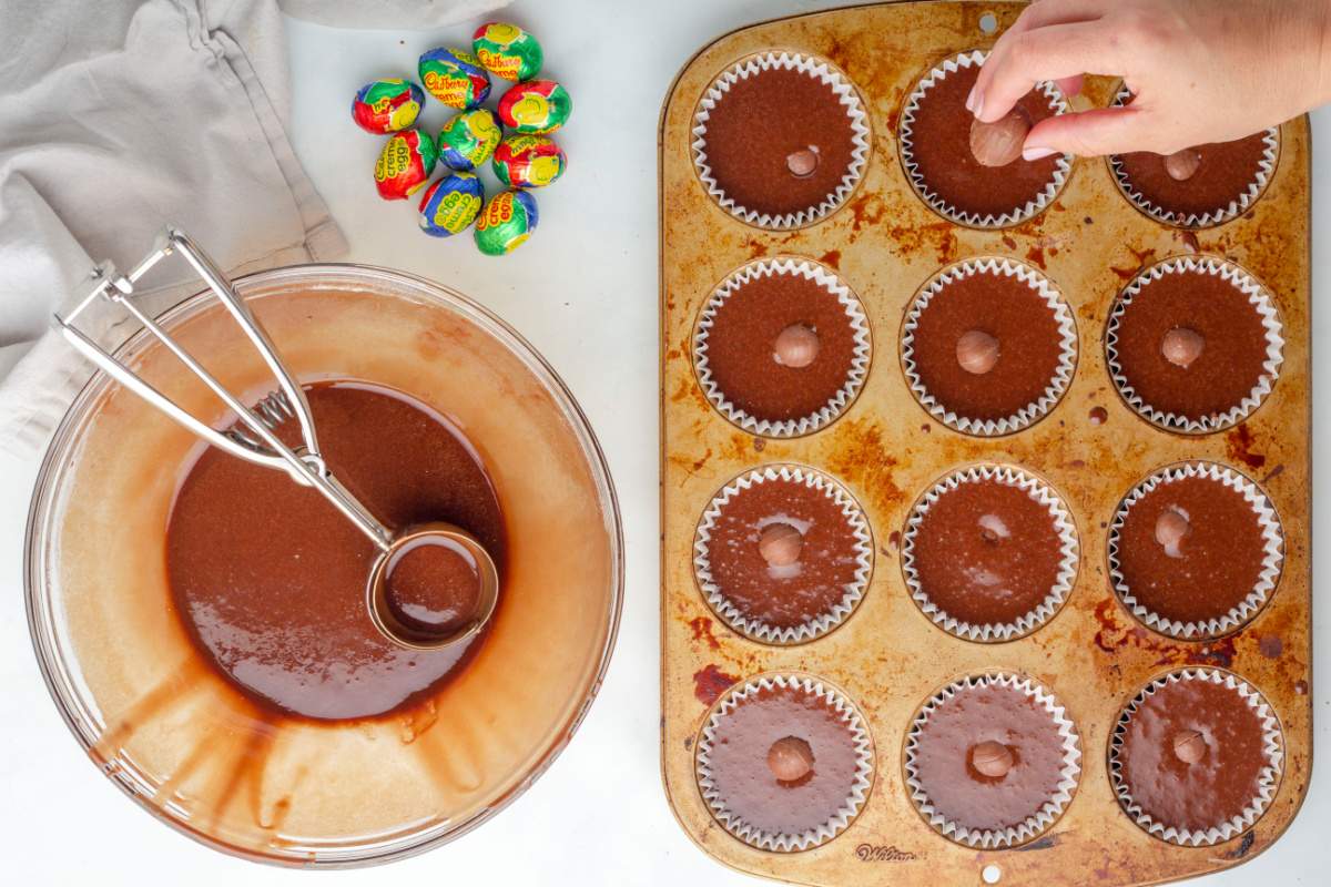 placing cadbury eggs into cupcake batter