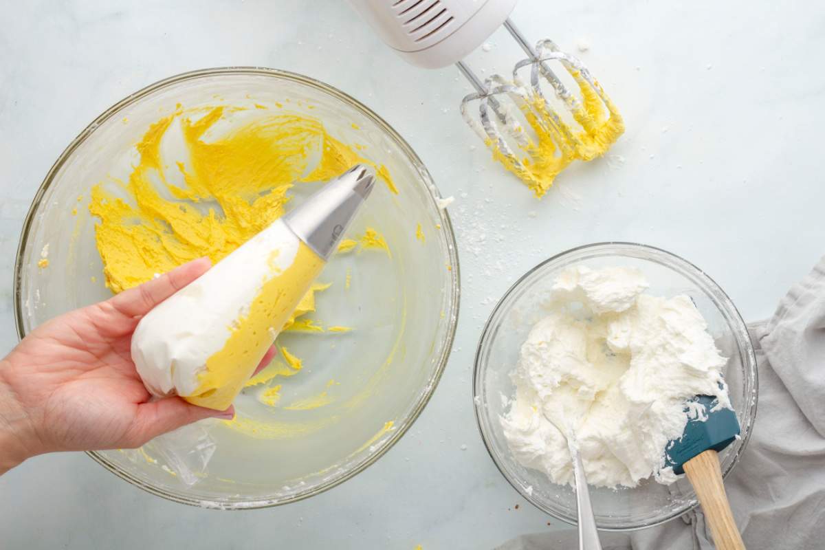 white and yellow frosting in piping bag
