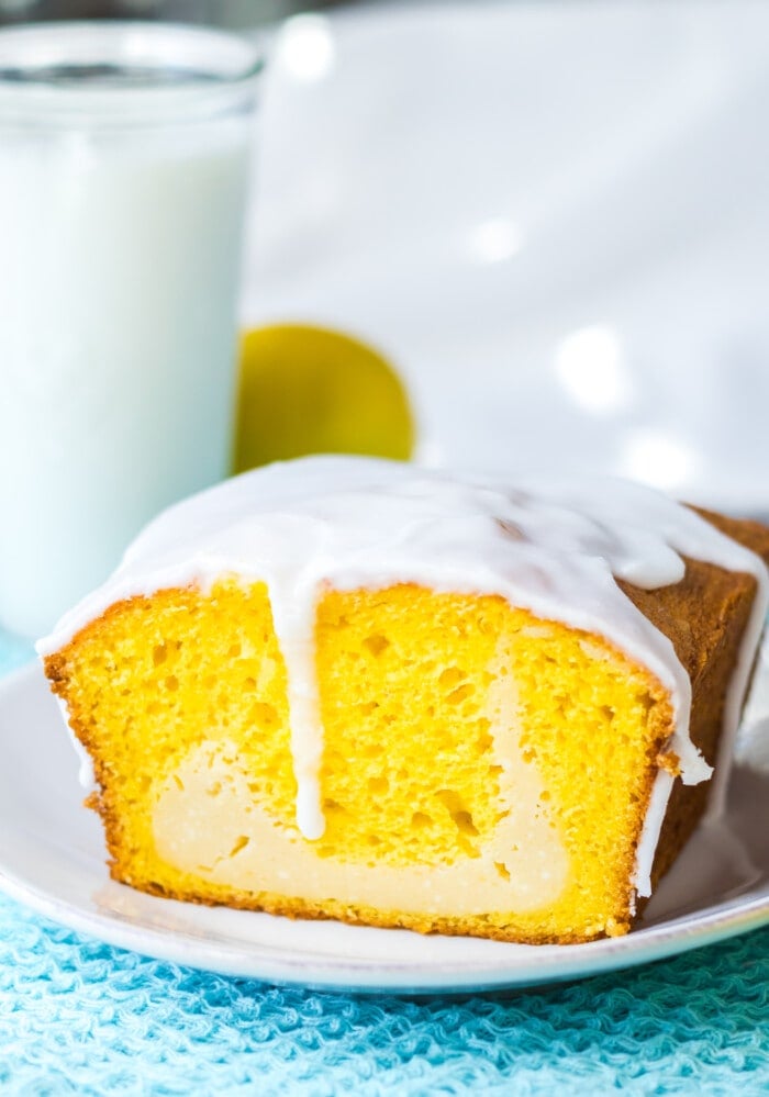Lemon bread with cream cheese on a blue tablecloth.