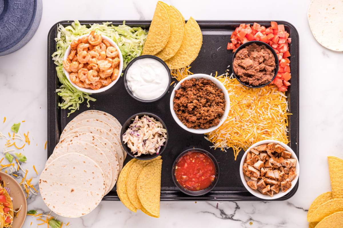adding tacos and taco topping to the board