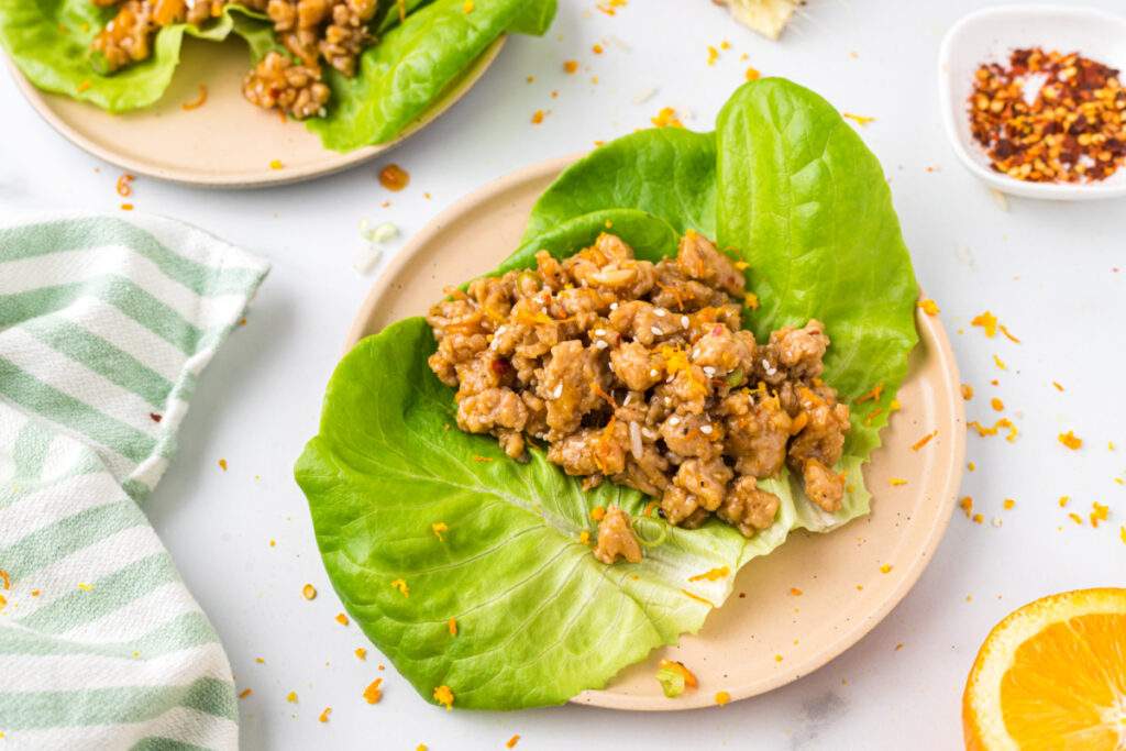 orange ground chicken in lettuce cup