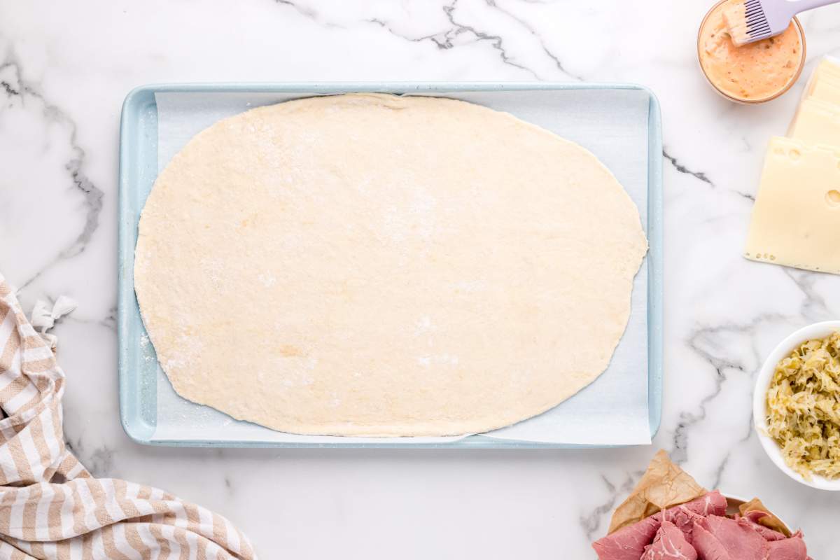 pizza dough on a baking sheet