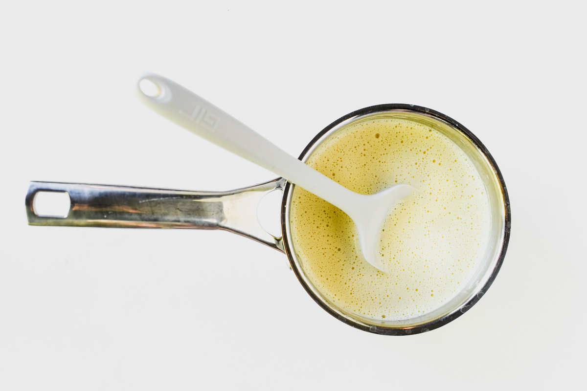 Cooking crème anglaise in a saucepan.