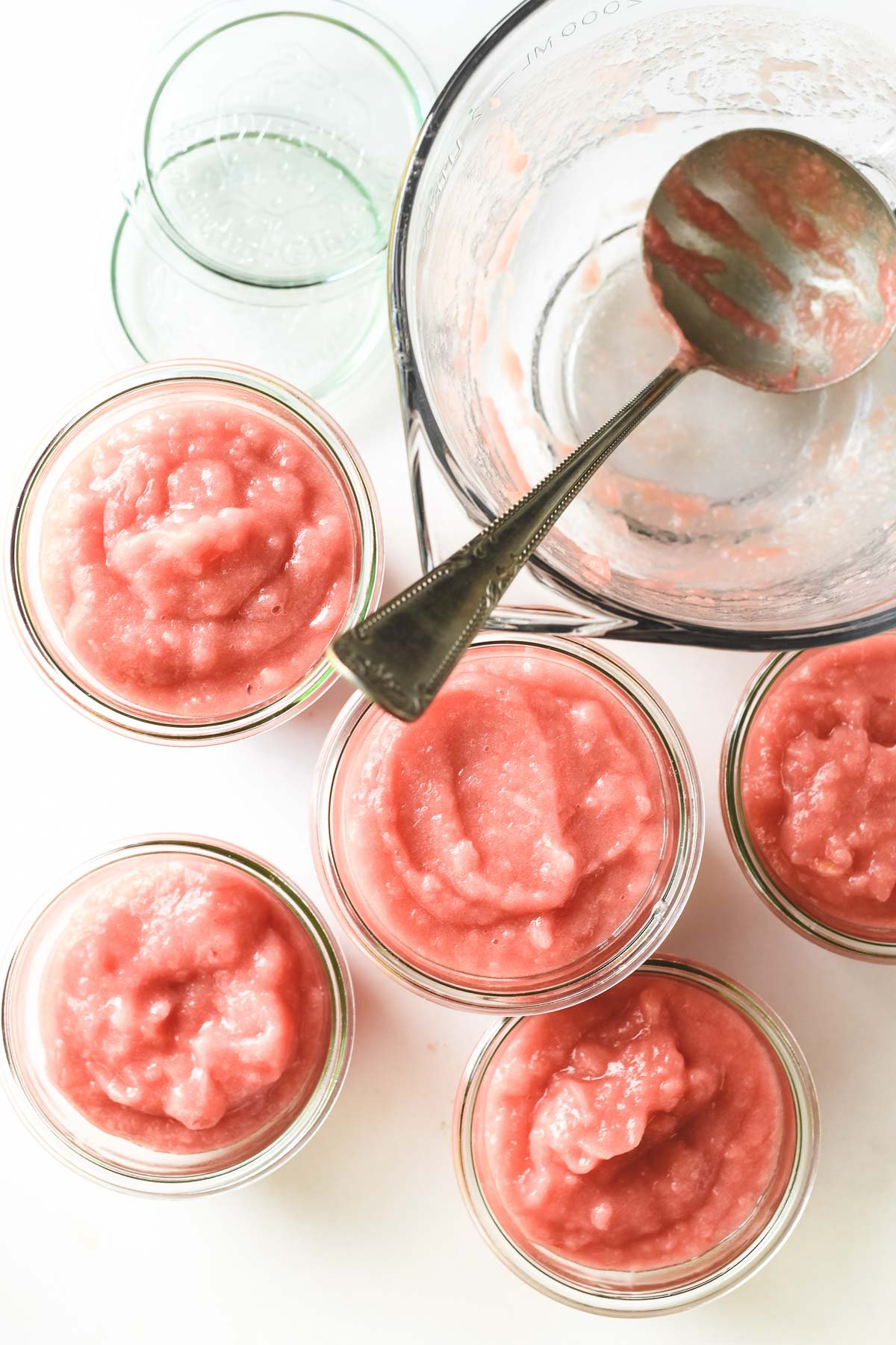 rhubarb applesauce in jars with ladle.