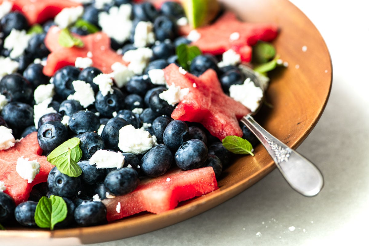 Red, white and cranberry fruit salad in a wooden bowl.