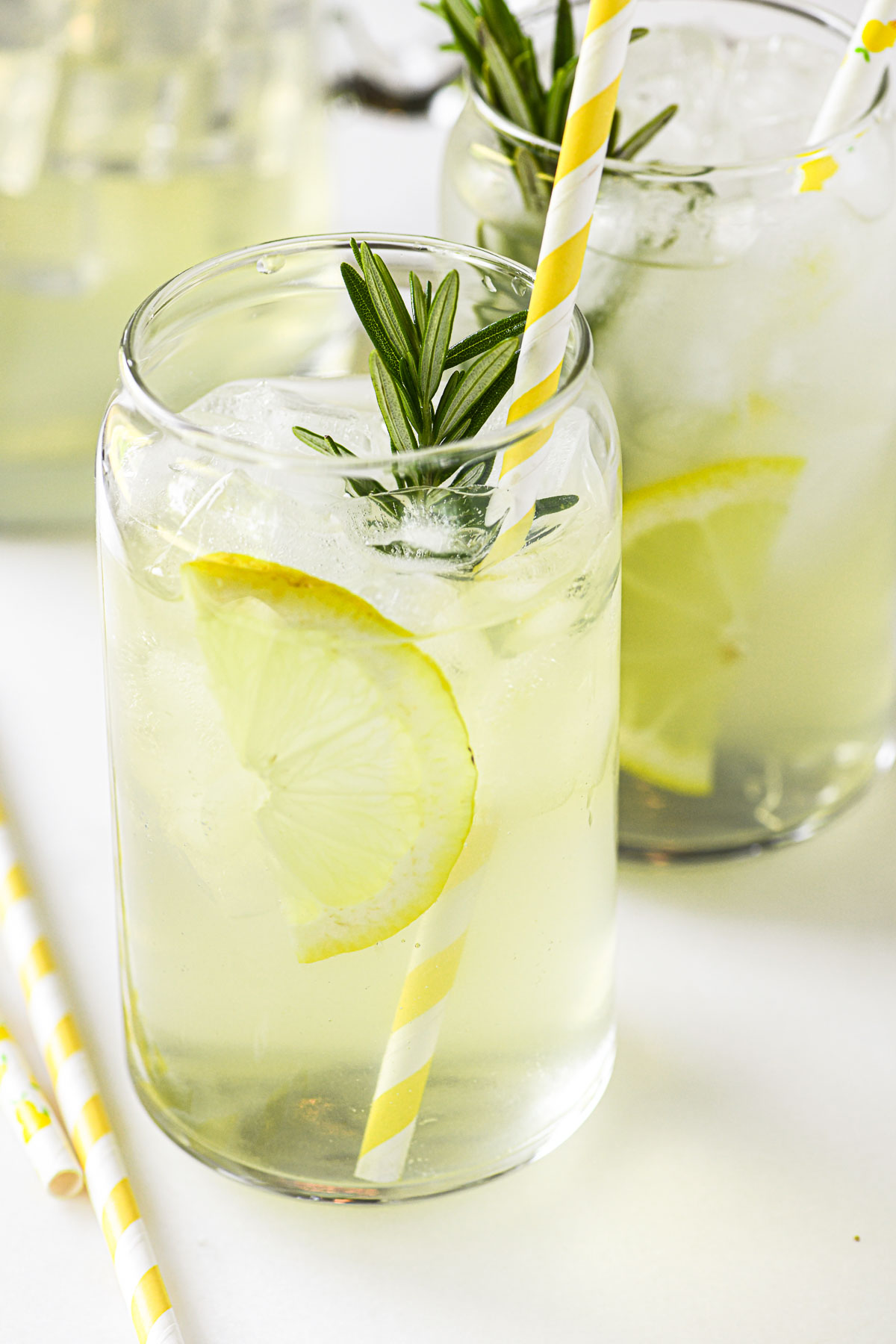 rosemary lemonade with a slice of lemon and fresh rosemary.