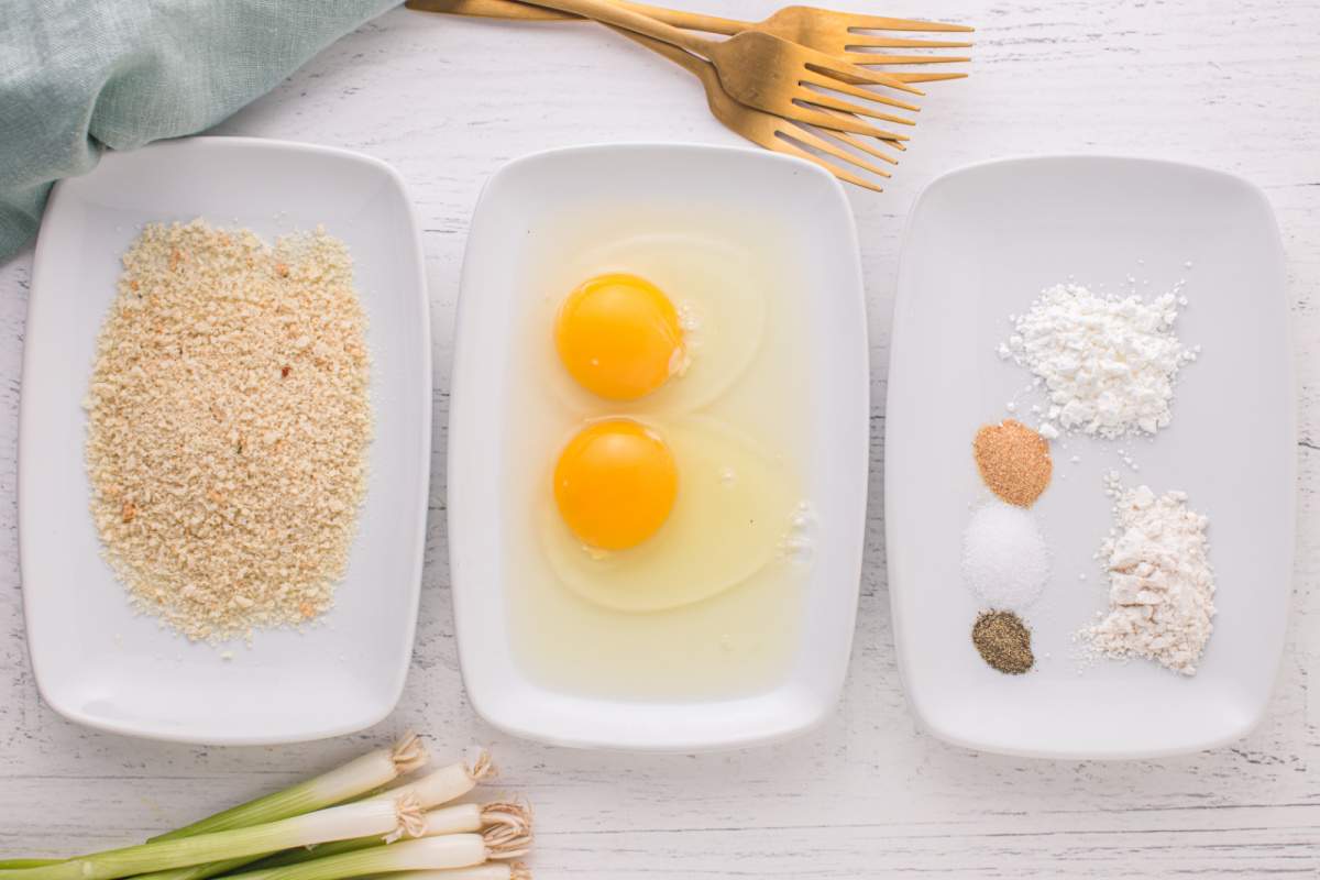 breadcrumbs, eggs, and seasonings in shallow bowls