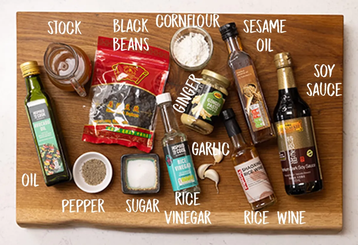 Ingredients for homemade black bean sauce on a wooden board.