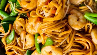 Wok of stir-fried Chinese noodles with prawns and vegetables