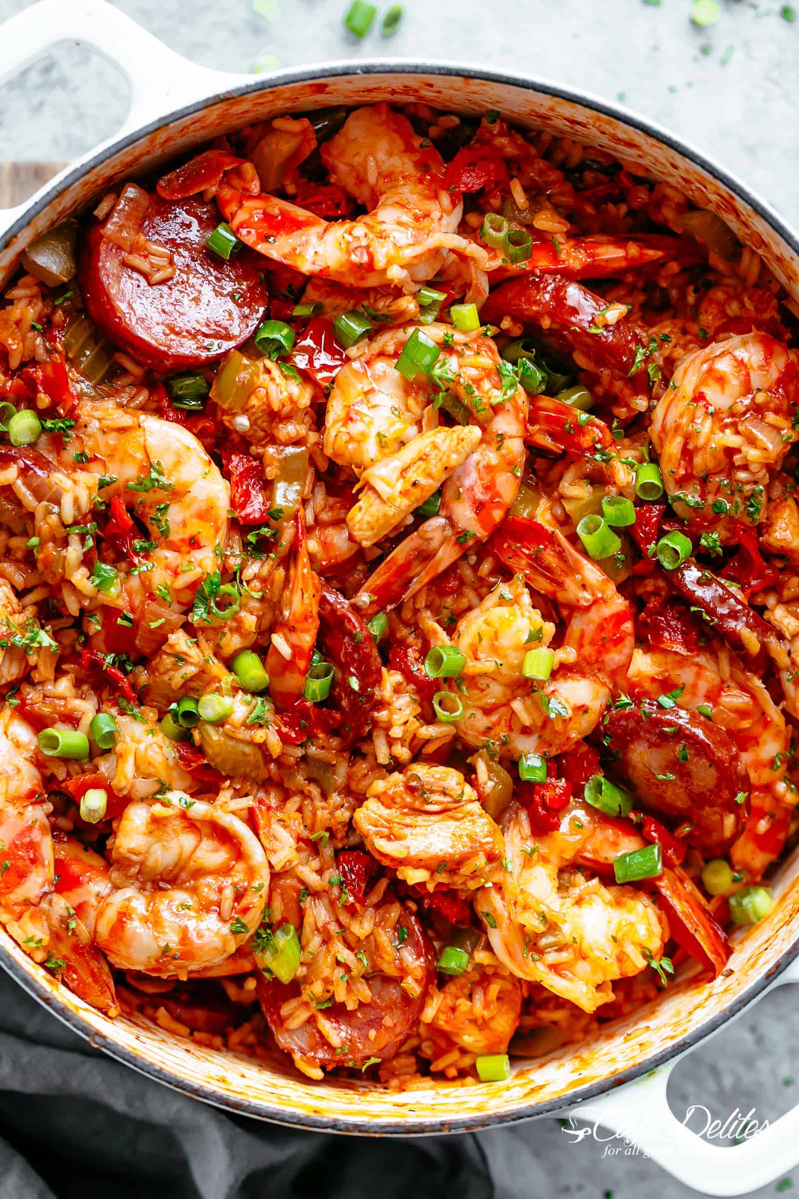 An authentic Creole Jambalaya recipe! A delicious one-pot meal brought to you from New Orleans is pure comfort food packed with chicken, shrimp, andouille sausage, rice, seasonings, spices, and incredible flavors! Ready and on the table in 45 minutes! | cafedelites.com
