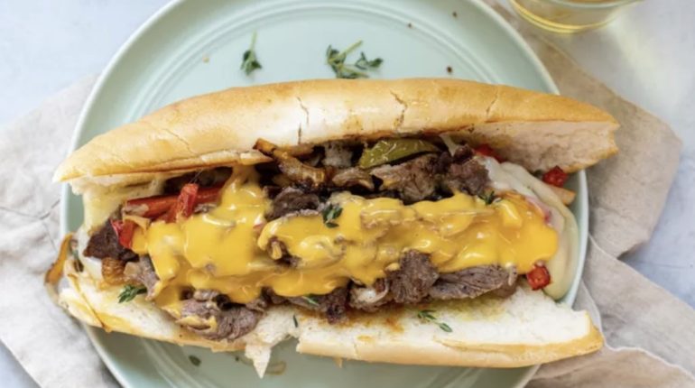 Cheesesteak History of the Cheesesteak Which sandwich is often associated with Philadelphia and typically made with thinly sliced beefsteak and melted cheese? 