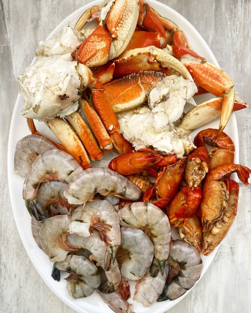 uncooked seafood on a white platter