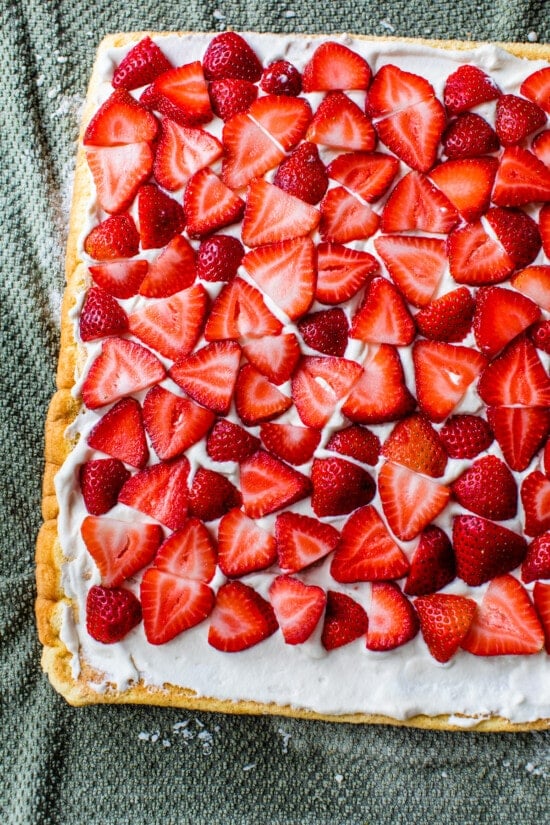 sponge cake topped with whipped cream and strawberries