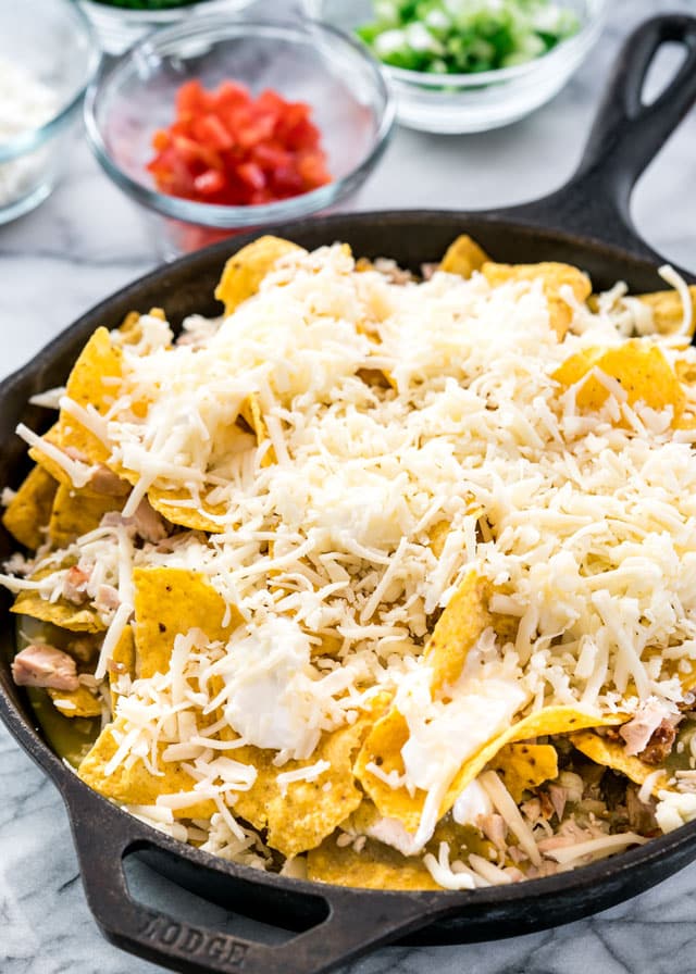 a pan full of chilaquiles covered with lots of cheese
