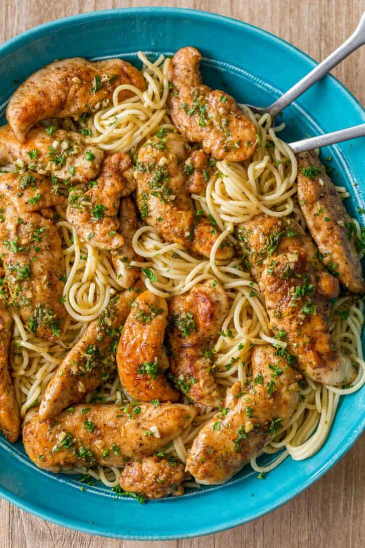 Chicken Scampi served over pasta in a bowl