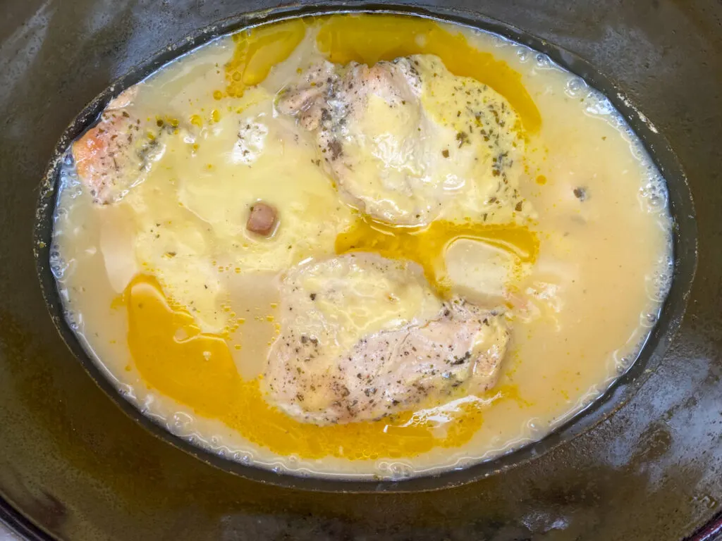 Cooked chicken and gravy in a Crock Pot