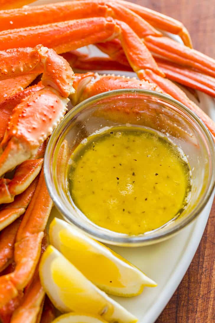 Crab Dipping Sauce in ramekin surrounded by crab legs