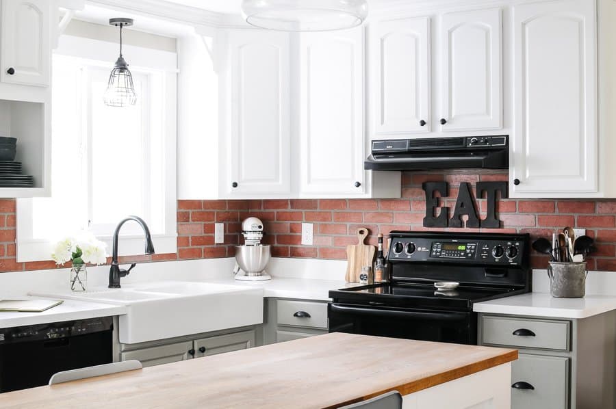 white kitchen with faux brick backsplash