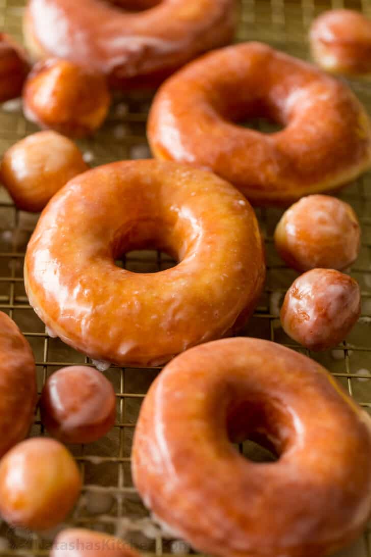 homemade glazed donuts resting on rack