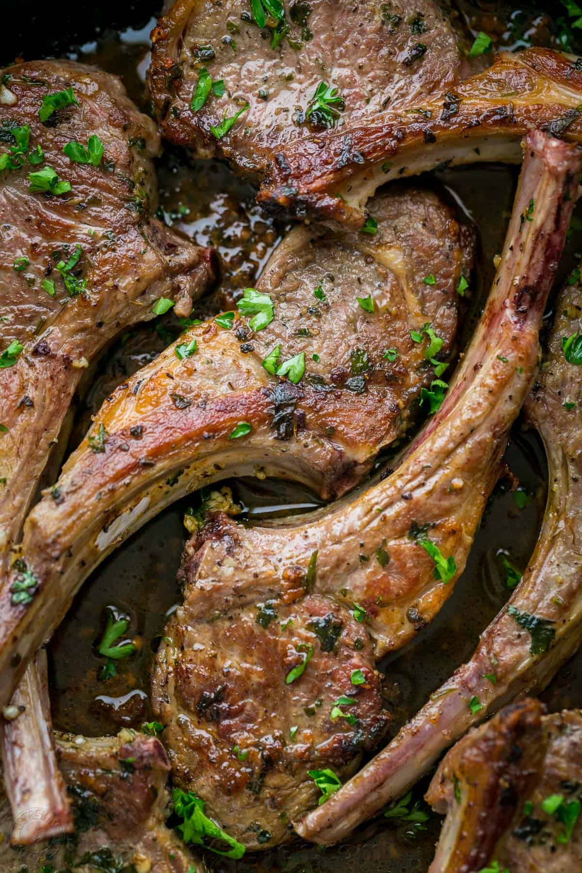 Up close cooked lamb chops seared on the outside 