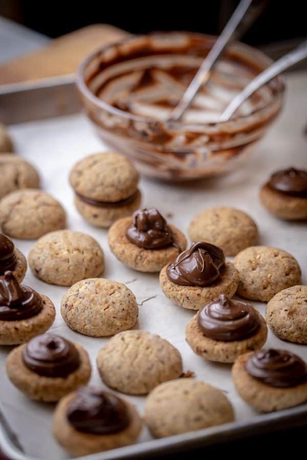 Italian Cookies Baci di Dama are made with two melt-in-your-mouth hazelnut cookies held together with a good dollop of dark chocolate.